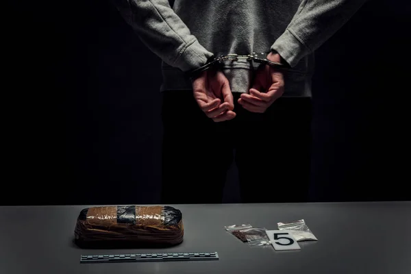 Arrested man in handcuffs with hands behind his back close-up on — Stock Photo, Image