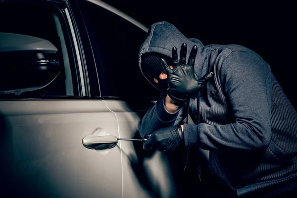 Een man met een Balaclava op zijn hoofd probeerde in te breken in de auto.. — Stockfoto