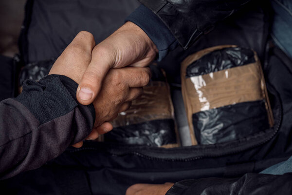 A person with money buys a dose of cocaine or heroin or other dr