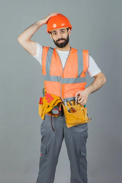 Studio portrait of a Builder, on a gray background — Stock Photo, Image