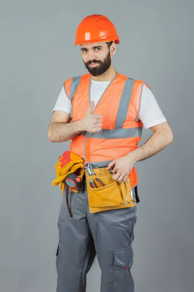 Studio portrait of a Builder, on a gray background — Stock Photo, Image