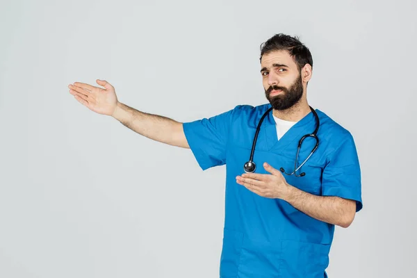 Portrait of doctor in blue uniform with his thumbs up. Isolated — Stock Photo, Image