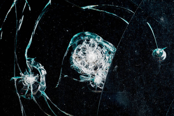 Cracks in car glass on a black background