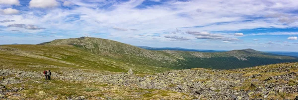 Panorama of the Ural Mountains with huge boulders on the hillsides. Beautiful summer landscape in good weather. Location North Ural Russia.