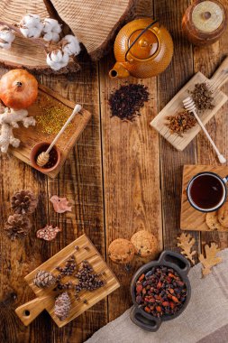 Sonbahar Kış natürmort. Bir çaydanlık ve farklı hediyeler ile ahşap bir tabloda çay. Daire yatıyordu. Alan metni altında. Konfor