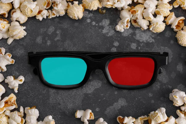 Glasses 3d to watch a movie in a frame of popcorn. Cinema concept.