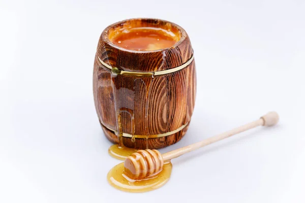 Kokulu taze bal akan bir damla bal beyaz bir arka plan üzerinde varil ve bal sopa. İzole.