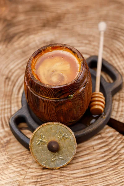 香りの良い蜂蜜と蜂蜜スティックそれテクスチャに木製のオープン バレルを見た クローズ アップ — ストック写真