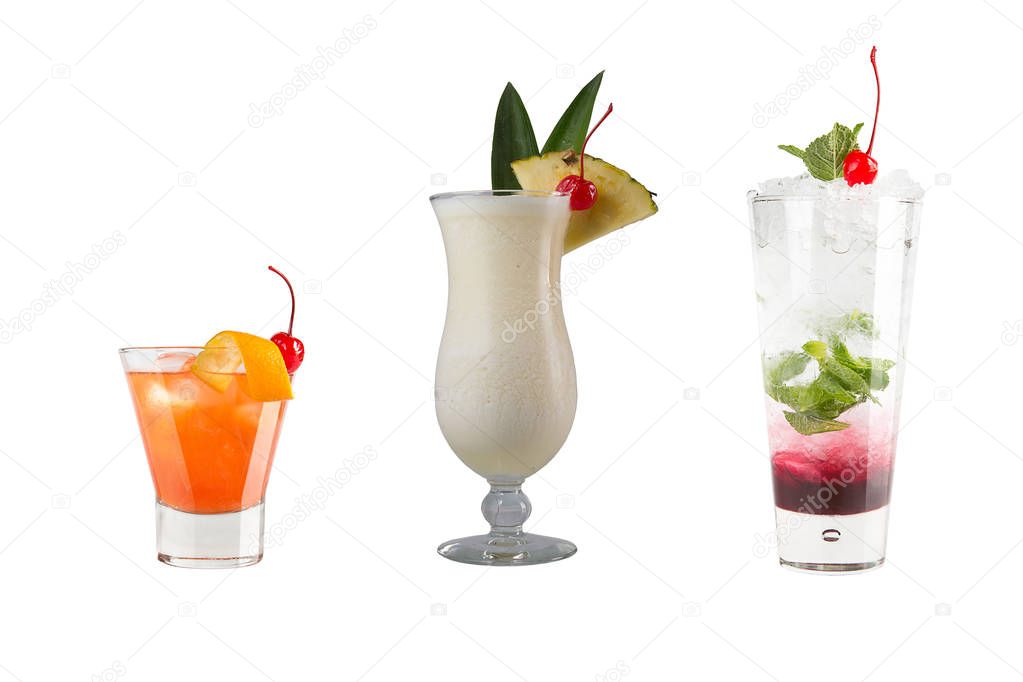 A variety of alcoholic drinks, beverages and cocktails on a white background. Three different drinks in glass goblets with Maraschino cherry decoration.