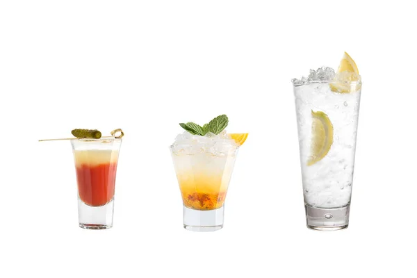 A variety of alcoholic drinks, beverages and cocktails on a white background. Three refreshing drinks in different glass goblets. — Stock Photo, Image