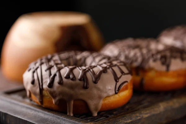 Concepção de culinária, cozimento e comida - close-up. Donuts no esmalte na placa decorativa . — Fotografia de Stock