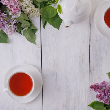 Tea set and flower decor against a background of white-painted w
