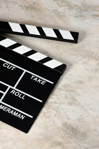 Clapper board with popcorn. Movie concept. Clapperboard on a textural background. Close-up.