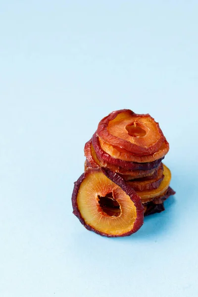 slices of dried plum on a blue background. dried fruits. eco. macro.