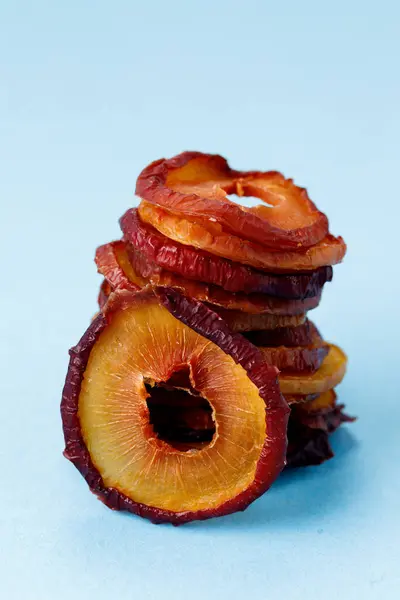 slices of dried plum on a blue background. dried fruits. eco. macro.