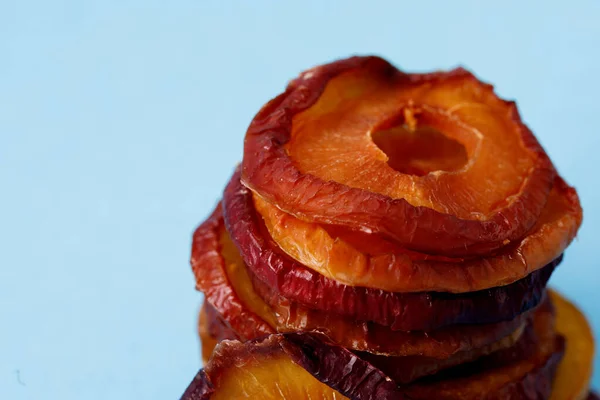 slices of dried plum on a blue background. dried fruits. eco. macro.