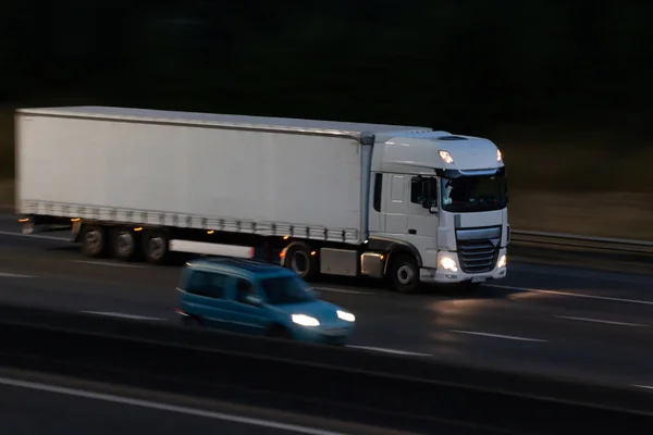 Lorry, Heavy goods vehicle in motion on the motorway at night