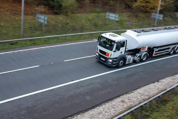 White Tanker lorry in motion on the road
