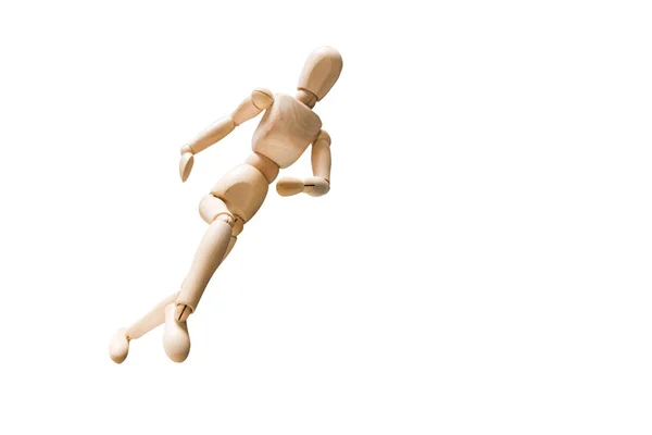 Wooden model on the run. Wooden mannequin in a running pose. Morning running, training. Jogging. The figure of wood runs dairy isolated background. Concept of caring for physical condition.