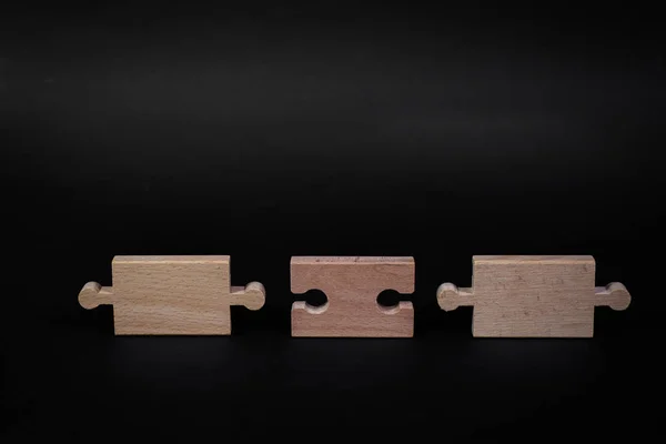 Wooden jigsaw puzzle with blank space. There is a matching puzzle next to it. The concept of solving problems, all problems can be solved, connection.