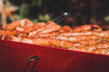 Görünümü ile sosis ızgara. Pişmiş sosis görünümünü. Grill'de aile ile birlikte vakit. Sosyal toplantılar, arkadaşlar. Sulu ve iyi ızgara sosis.