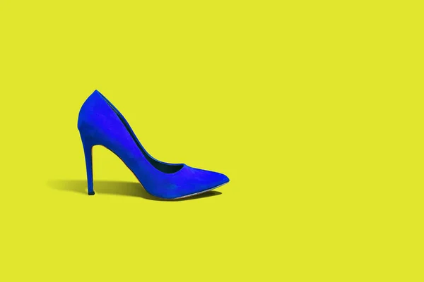 High heels, blue high heel on a yellow pastel background. Fashion concept, catwalk. Online store, fashion store, sale of shoes. Footwear Female shoes. A few different shoes.