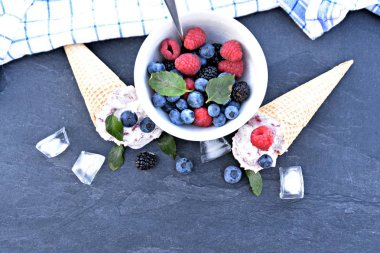  waffle dondurma konileri taze çilek ve nane koyu mermer yüzey üzerinde yatan orman meyve dondurma topları ile dolu - lezzetli meyveli dondurma ile serin bir yaz macera için kavram