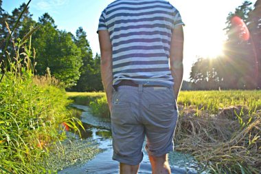 Ayaklarda yakın çekim - ormanda çakıl bir yol boyunca yürür ve yazlık sıcaklıklarda doğada rahatlatır