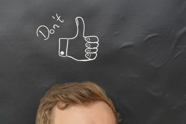 head in front of a board with drawn thumb up
