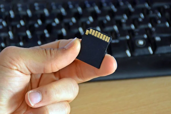 holding micro sd card in the hand