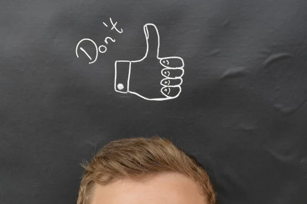 head in front of a board with drawn thumb up