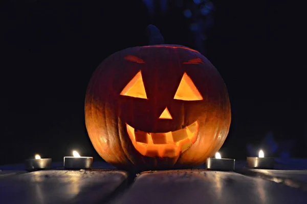 spooky little halloween pumpkin glowing in the dark
