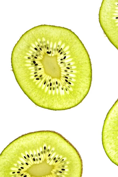 Kiwi Fatiado Fica Fundo Leve Através Das Fatias Kiwi Finas — Fotografia de Stock