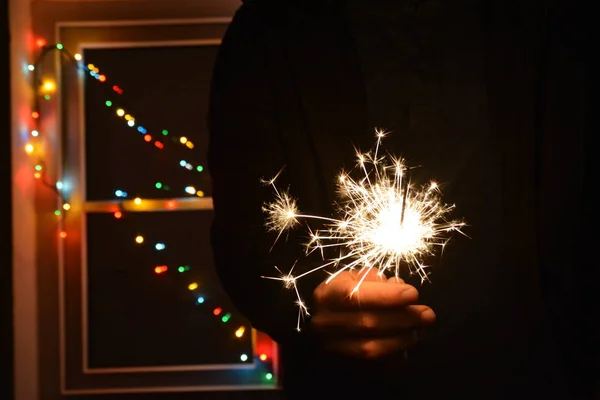 Segurando Sparkler Frente Uma Fada Luzes Coloridas — Fotografia de Stock