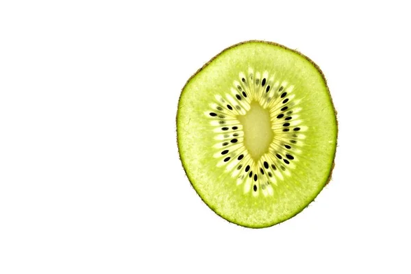 Eine Geschnittene Kiwi Liegt Auf Hellem Hintergrund Durch Die Dünnen — Stockfoto