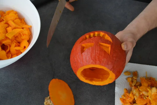carving out a pumpkin for halloween