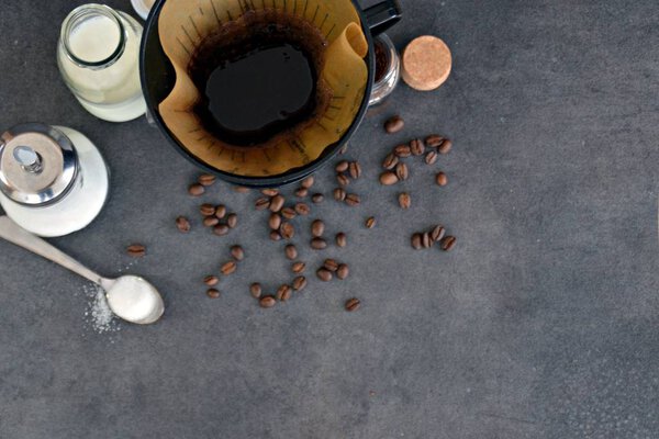  coffee in a cup with milk and sugar beside 