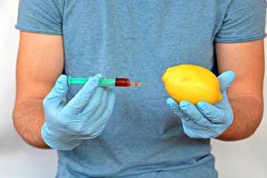 bir limon içine kırmızı ilaç enjekte