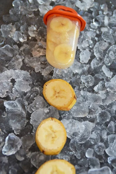 Homemade banana ice cream with pieces on ice cubes