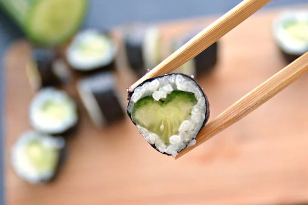 きゅうりときゅうりでハート型の寿司を食べる 寿司に恋する象徴としてクローズアップ — ストック写真