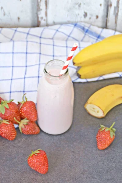 Homemade milk shake with strawberries and bananas as a perfect refreshment in summer