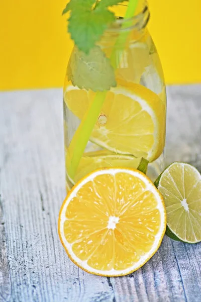 Con Vaso Lleno Hielo Limas Limones Menta Mano Una Combinación —  Fotos de Stock