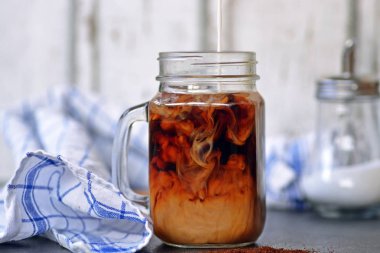 bir buzlu kahve içine süt dökün