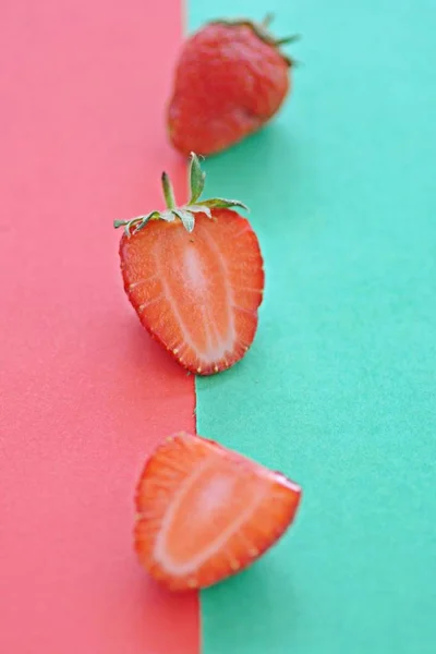Strawberry close-up on two colored background, fruits summer