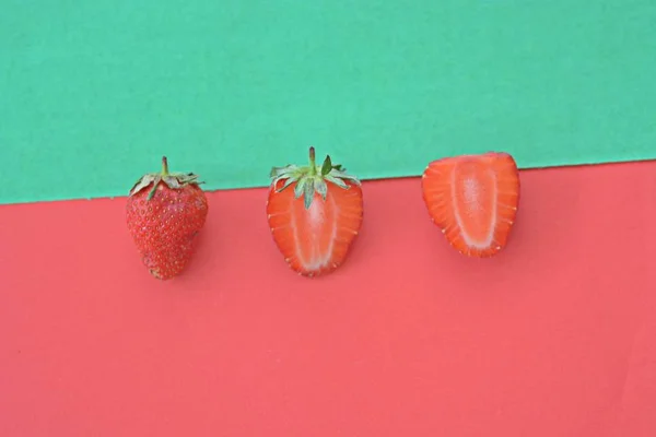 Strawberry close-up on two colored background, fruits summer