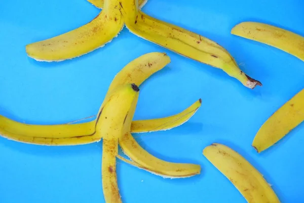 在色彩艳丽的背景前剥落香蕉皮 — 图库照片