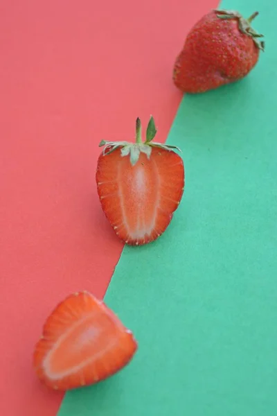 Strawberry close-up on two colored background, fruits summer