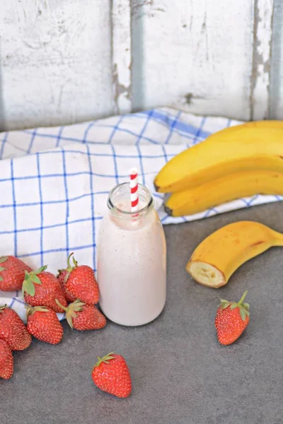 Homemade milk shake with strawberries and bananas as a perfect refreshment in summer