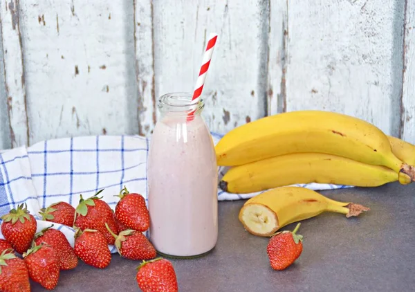 Homemade milk shake with strawberries and bananas as a perfect refreshment in summer