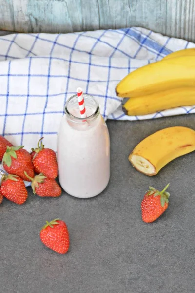 Homemade milk shake with strawberries and bananas as a perfect refreshment in summer